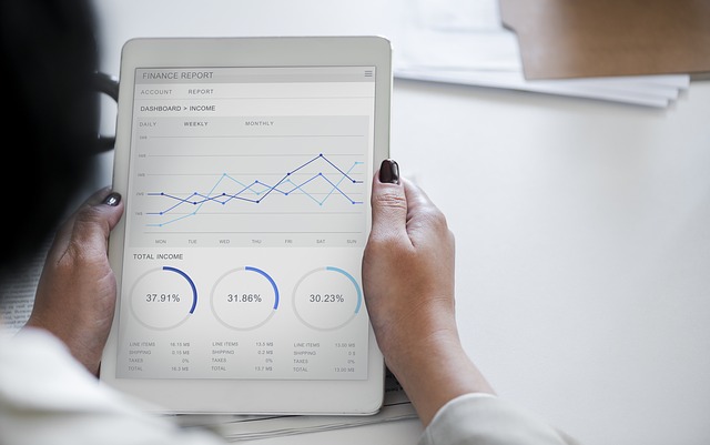 woman looking at data on tablet